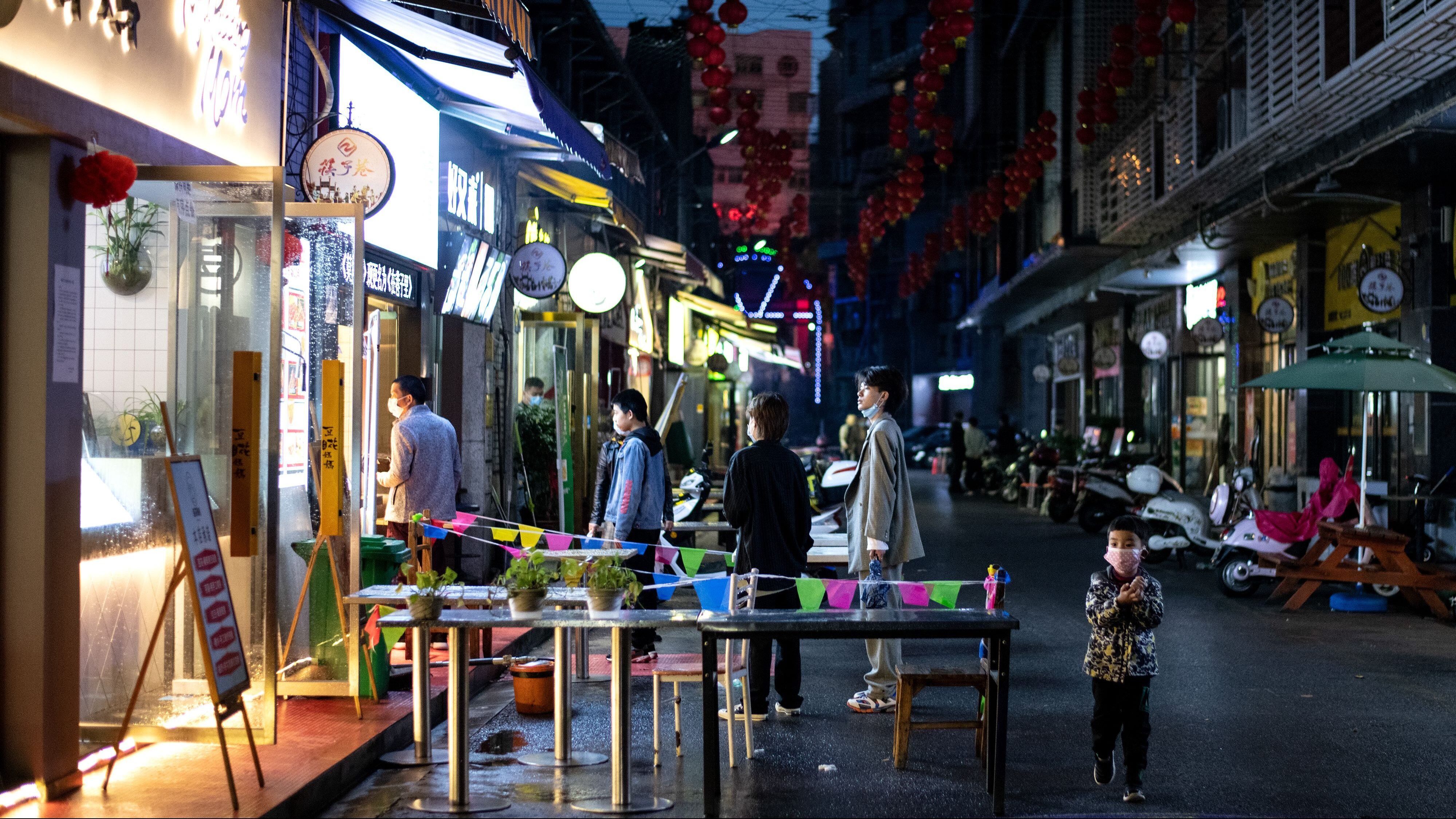 People wearing facemasks as a preventive measure against the COVID-19 coronavirus checks queue up to order take out food in Huanggang, in Chinas central Hubei province on March 26, 2020. (Photo by NOEL CELIS / AFP) (Photo by NOEL CELIS/AFP via Getty Images)