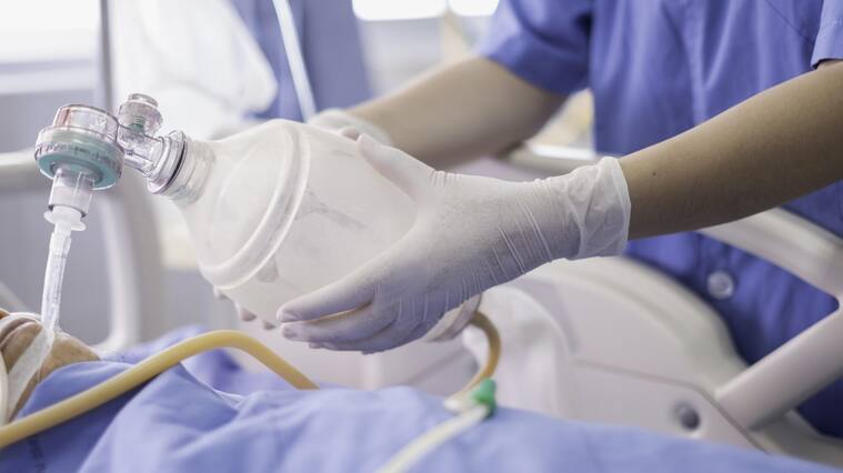 doctor holding oxygen ambu bag over patient given oxygen to patient by intubation tube in ICU/Emergency room