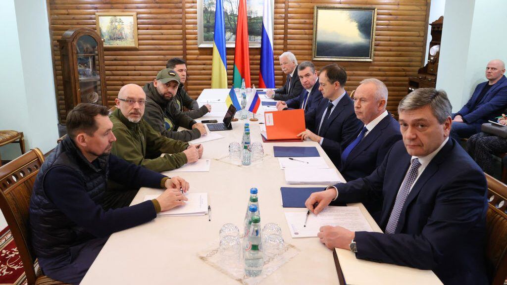 Deputy Minister of Foreign Affairs of Ukraine Mykola Tochytskyi, left, Minister of Defense of Ukraine Oleksiy Reznikov, second left, the Head of the Ukrainian Servant of the People faction Davyd Arakhamia, third left, Adviser to the Head of the Office of the President of Ukraine Mykhailo Podoliak, fourth left, Russian Ambassador to Belarus Boris Gryzlov, fifth right, Leonid Slutsky, chairman of the Russian State Duma's International Affairs Committee, fourth right, Russian Presidential Aide and the head of the Russian delegation Vladimir Medinsky, third right, Deputy Minister of Defense Alexander Fomin, second right, and Deputy Foreign Minister Andrei Rudenko pose prior the talks between delegations from Ukraine and Russia in Belarus' Brest region on March 7, 2022. - - Belarus OUT (Photo by Maxim GUCHEK / BELTA / AFP) / Belarus OUT (Photo by MAXIM GUCHEK/BELTA/AFP via Getty Images)