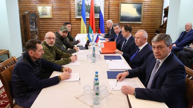 Deputy Minister of Foreign Affairs of Ukraine Mykola Tochytskyi, left, Minister of Defense of Ukraine Oleksiy Reznikov, second left, the Head of the Ukrainian Servant of the People faction Davyd Arakhamia, third left, Adviser to the Head of the Office of the President of Ukraine Mykhailo Podoliak, fourth left, Russian Ambassador to Belarus Boris Gryzlov, fifth right, Leonid Slutsky, chairman of the Russian State Duma's International Affairs Committee, fourth right, Russian Presidential Aide and the head of the Russian delegation Vladimir Medinsky, third right, Deputy Minister of Defense Alexander Fomin, second right, and Deputy Foreign Minister Andrei Rudenko pose prior the talks between delegations from Ukraine and Russia in Belarus' Brest region on March 7, 2022. - - Belarus OUT (Photo by Maxim GUCHEK / BELTA / AFP) / Belarus OUT (Photo by MAXIM GUCHEK/BELTA/AFP via Getty Images)