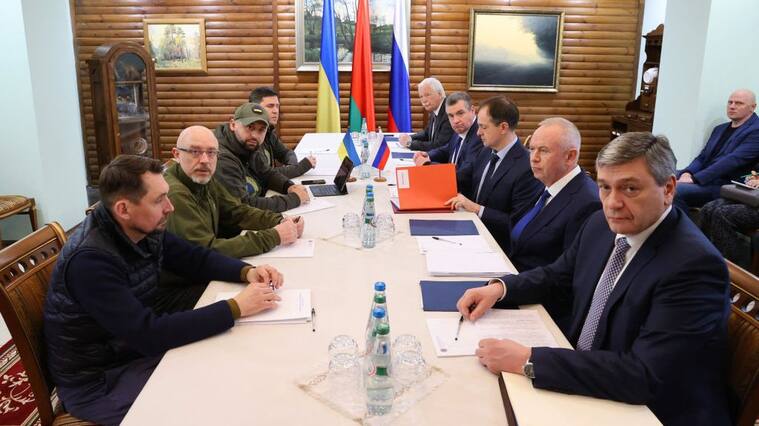 Deputy Minister of Foreign Affairs of Ukraine Mykola Tochytskyi, left, Minister of Defense of Ukraine Oleksiy Reznikov, second left, the Head of the Ukrainian Servant of the People faction Davyd Arakhamia, third left, Adviser to the Head of the Office of the President of Ukraine Mykhailo Podoliak, fourth left, Russian Ambassador to Belarus Boris Gryzlov, fifth right, Leonid Slutsky, chairman of the Russian State Duma's International Affairs Committee, fourth right, Russian Presidential Aide and the head of the Russian delegation Vladimir Medinsky, third right, Deputy Minister of Defense Alexander Fomin, second right, and Deputy Foreign Minister Andrei Rudenko pose prior the talks between delegations from Ukraine and Russia in Belarus' Brest region on March 7, 2022. - - Belarus OUT (Photo by Maxim GUCHEK / BELTA / AFP) / Belarus OUT (Photo by MAXIM GUCHEK/BELTA/AFP via Getty Images)