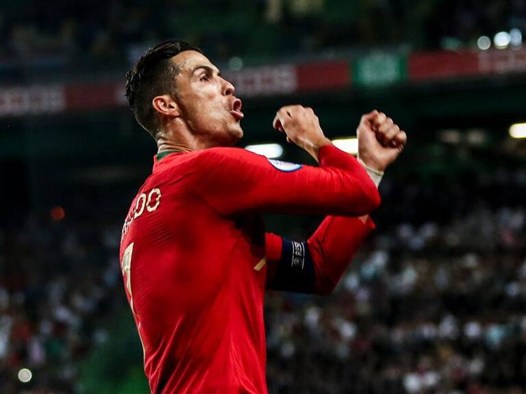 Portugal's forward Cristiano Ronaldo celebrates after scoring a goal during the Euro 2020 qualifier group B football match between Portugal and Luxembourg at the Jose Alvalade stadium in Lisbon on October 11, 2019. (Photo by CARLOS COSTA / AFP) (Photo by CARLOS COSTA/AFP via Getty Images)
