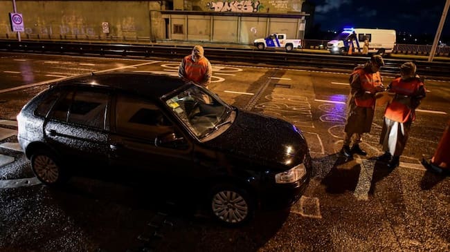 Argentine prefecture officials check a person's permit to circulate during a curfew early on April 9, 2021, at the Pueyrredon Bridge in Buenos Aires. - Argentina's President Alberto Fernandez announced a three-week overnight curfew on April 7, following a second consecutive day of record coronavirus infections. (Photo by RONALDO SCHEMIDT / AFP) (Photo by RONALDO SCHEMIDT/AFP via Getty Images)