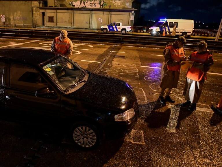 Argentine prefecture officials check a person&#039;s permit to circulate during a curfew early on April 9, 2021, at the Pueyrredon Bridge in Buenos Aires. - Argentina&#039;s President Alberto Fernandez announced a three-week overnight curfew on April 7, following a second consecutive day of record coronavirus infections. (Photo by RONALDO SCHEMIDT / AFP) (Photo by RONALDO SCHEMIDT/AFP via Getty Images)