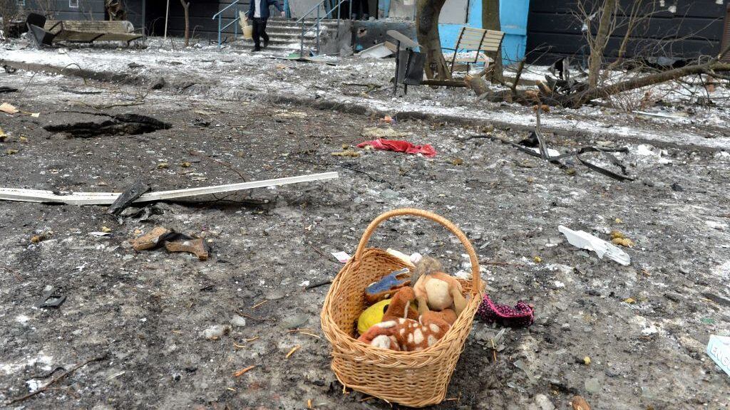 A man carries a bucket full of broken glass following a shelling in Ukraine's second-biggest city of Kharkiv on March 7, 2022. - On the 12th day of Russia's invasion of Ukraine March 7, 2022, Russian forces pressed a siege of the key southern port of Mariupol and sought to increase pressure on the capital Kyiv. Kyiv remains under Ukrainian control as does Kharkiv in the east, with the overall Russian ground advance little changed over the last 24 hours in the face of fierce Ukrainian resistance. (Photo by Sergey BOBOK / AFP) (Photo by SERGEY BOBOK/AFP via Getty Images)