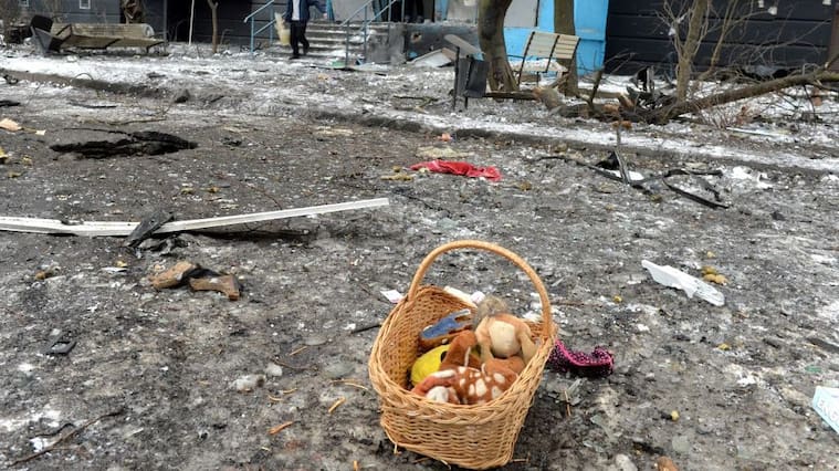 A man carries a bucket full of broken glass following a shelling in Ukraine's second-biggest city of Kharkiv on March 7, 2022. - On the 12th day of Russia's invasion of Ukraine March 7, 2022, Russian forces pressed a siege of the key southern port of Mariupol and sought to increase pressure on the capital Kyiv. Kyiv remains under Ukrainian control as does Kharkiv in the east, with the overall Russian ground advance little changed over the last 24 hours in the face of fierce Ukrainian resistance. (Photo by Sergey BOBOK / AFP) (Photo by SERGEY BOBOK/AFP via Getty Images)