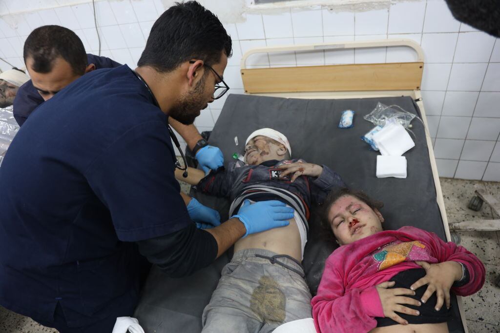 Médico asiste a dos niños gravemente heridos en el Hospital Al Ahli luego de los nuevos bombardeos de Israel en contra de la Franja de Gaza