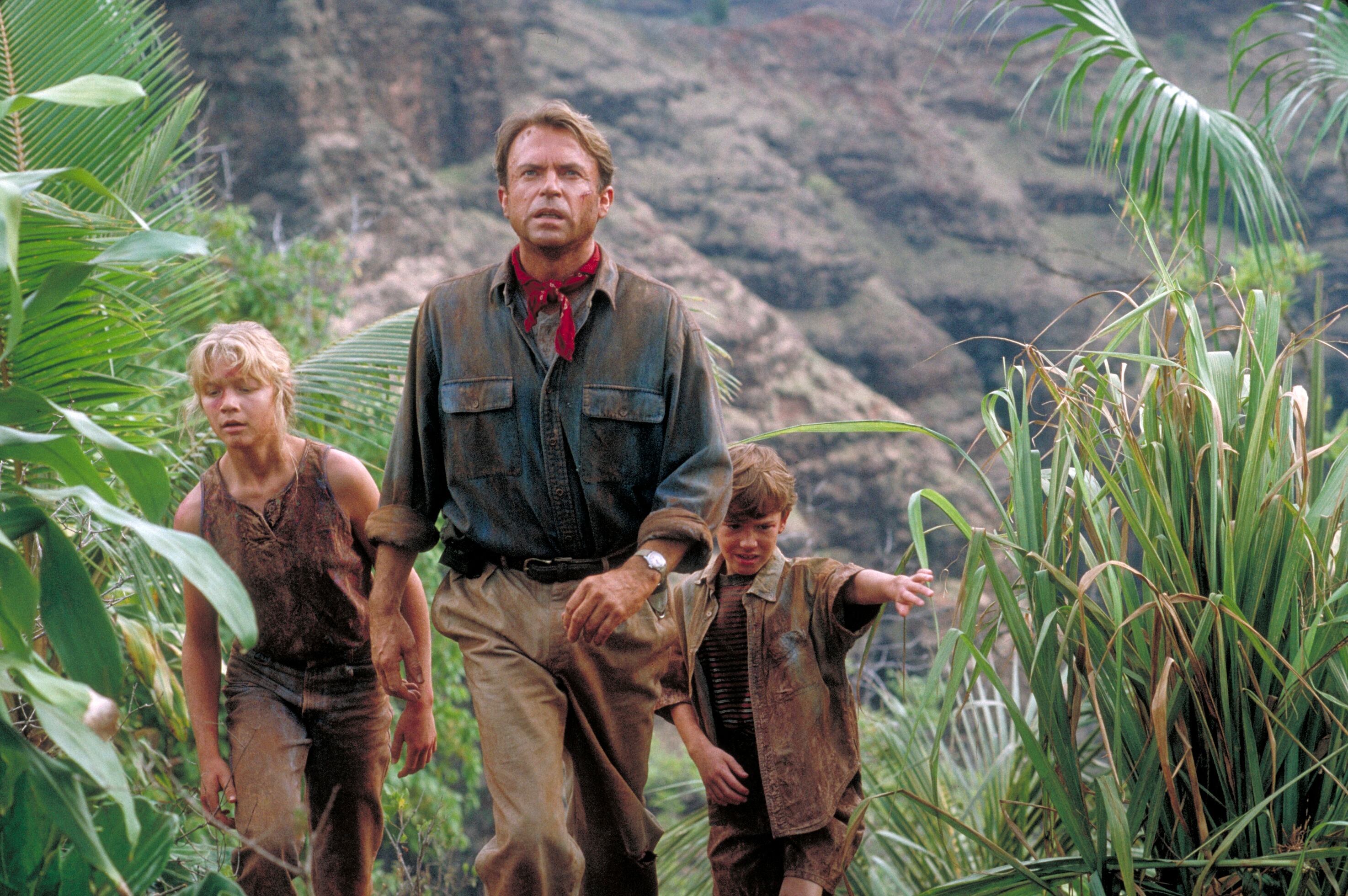 Actor Sam Neill as Dr. Alan Grant, with Ariana Richards (left) and Joseph Mazzello (right) as Lex and Tim, in a scene from the film 'Jurassic Park', 1993. (Photo by Murray Close/Getty Images)