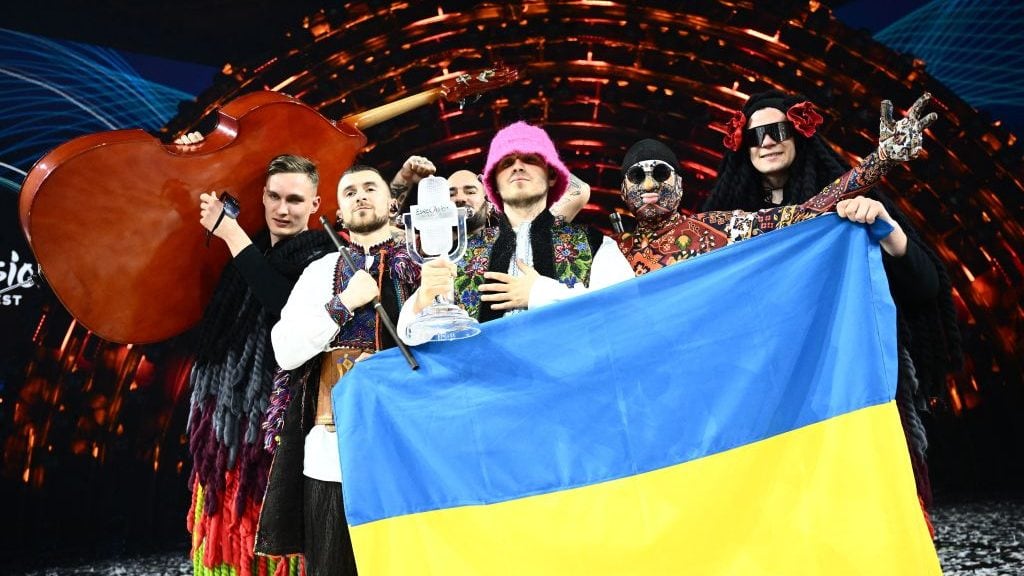 Members of the band "Kalush Orchestra" pose onstage with the winner's trophy and Ukraine's flags after winning on behalf of Ukraine the Eurovision Song contest 2022 on May 14, 2022 at the Pala Alpitour venue in Turin. (Photo by Marco BERTORELLO / AFP) (Photo by MARCO BERTORELLO/AFP via Getty Images)