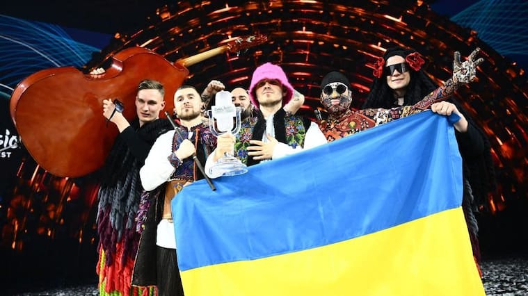 Members of the band "Kalush Orchestra" pose onstage with the winner's trophy and Ukraine's flags after winning on behalf of Ukraine the Eurovision Song contest 2022 on May 14, 2022 at the Pala Alpitour venue in Turin. (Photo by Marco BERTORELLO / AFP) (Photo by MARCO BERTORELLO/AFP via Getty Images)