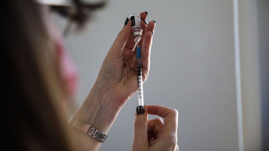 TEL AVIV, ISRAEL - FEBRUARY 10: A health worker prepares the first dose of coronavirus (Covid-19) vaccination at a vaccination center as refugees, migrant workers and foreigners with work permits start to be vaccinated in Tel Aviv, Israel on February 10, 2021. (Photo by Mostafa Alkharouf/Anadolu Agency via Getty Images)