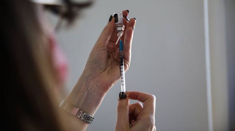TEL AVIV, ISRAEL - FEBRUARY 10: A health worker prepares the first dose of coronavirus (Covid-19) vaccination at a vaccination center as refugees, migrant workers and foreigners with work permits start to be vaccinated in Tel Aviv, Israel on February 10, 2021. (Photo by Mostafa Alkharouf/Anadolu Agency via Getty Images)