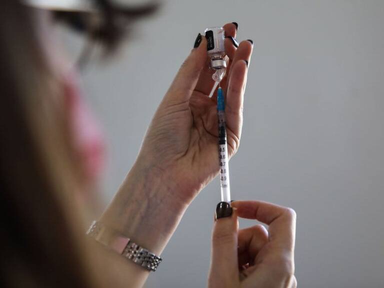 TEL AVIV, ISRAEL - FEBRUARY 10: A health worker prepares the first dose of coronavirus (Covid-19) vaccination at a vaccination center as refugees, migrant workers and foreigners with work permits start to be vaccinated in Tel Aviv, Israel on February 10, 2021. (Photo by Mostafa Alkharouf/Anadolu Agency via Getty Images)