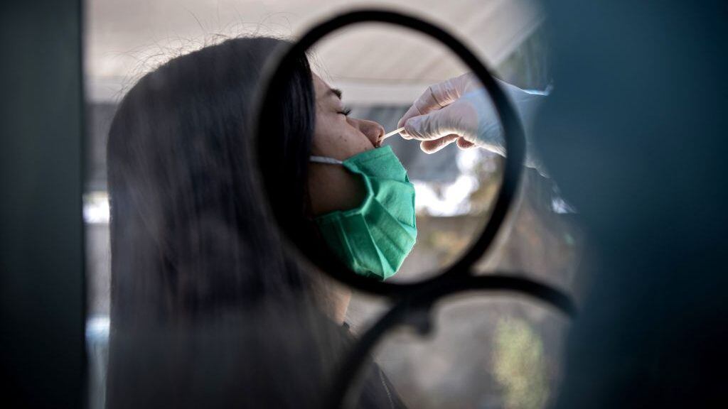 A woman undergoes a PCR test for the novel coronavirus at the mobile medical center of the municipality of El Bosque, in Santiago on August 25, 2020. - After critical weeks in May and June, Chile managed to keep the new cases of coronavirus stable in most of the country. To avoid upsurges, it is now investing efforts to continue testing massively and to reinforce traceability, the key link to lift quarantines. (Photo by MARTIN BERNETTI / AFP) (Photo by MARTIN BERNETTI/AFP via Getty Images)