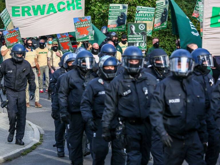 BERLIN, GERMANY - OCTOBER 03: Supporters of the far-right Third Way (Der Dritte Weg) neo-Nazi political party march on the 30th anniversary of German reunification in Hohenschoenhausen district on October 3, 2020 in Berlin, Germany. Several radical groups, including the Third Way as well as coronavirus skeptics preaching the overthrow of the German government, are taking to the streets today in Berlin. The Third Way has been active since 2013 and is an offshoot of the mostly defunct far-right NPD (National Democratic Party of Germany). (Photo by Omer Messinger/Getty Images)