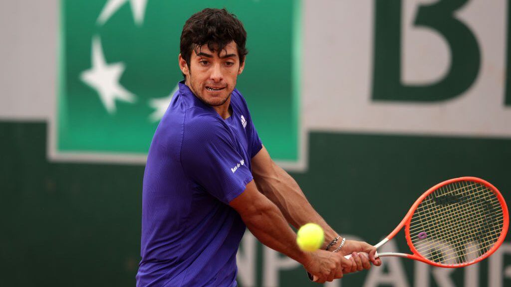 PARIS, FRANCE - JUNE 02: Cristian Garin of Chile plays a backhand during his mens second round match against Mackenzie McDonald of the United States during day four of the 2021 French Open at Roland Garros  on June 02, 2021 in Paris, France. (Photo by Adam Pretty/Getty Images)