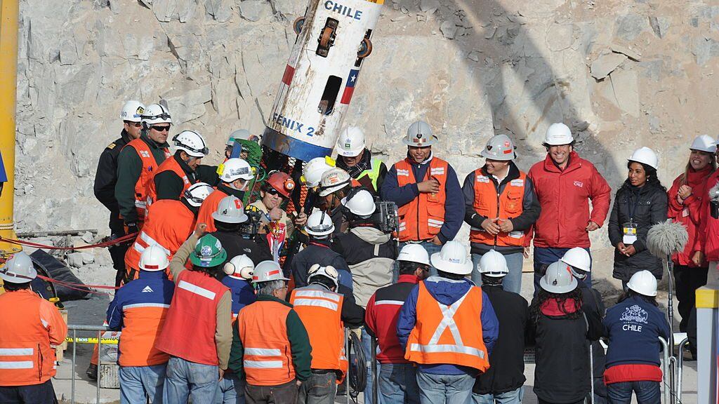 Chilean miner Alex Vega gives the thumbs up upon exiting the Fenix capsule after being brought to the surface in the ninth place, on October 13, 2010 following a 10-week ordeal in the collapsed San Jose mine, near Copiapo, 800 km north of Santiago, Chile. AFP PHOTO/ Rodrigo ARANGUA (Photo credit should read RODRIGO ARANGUA/AFP via Getty Images)