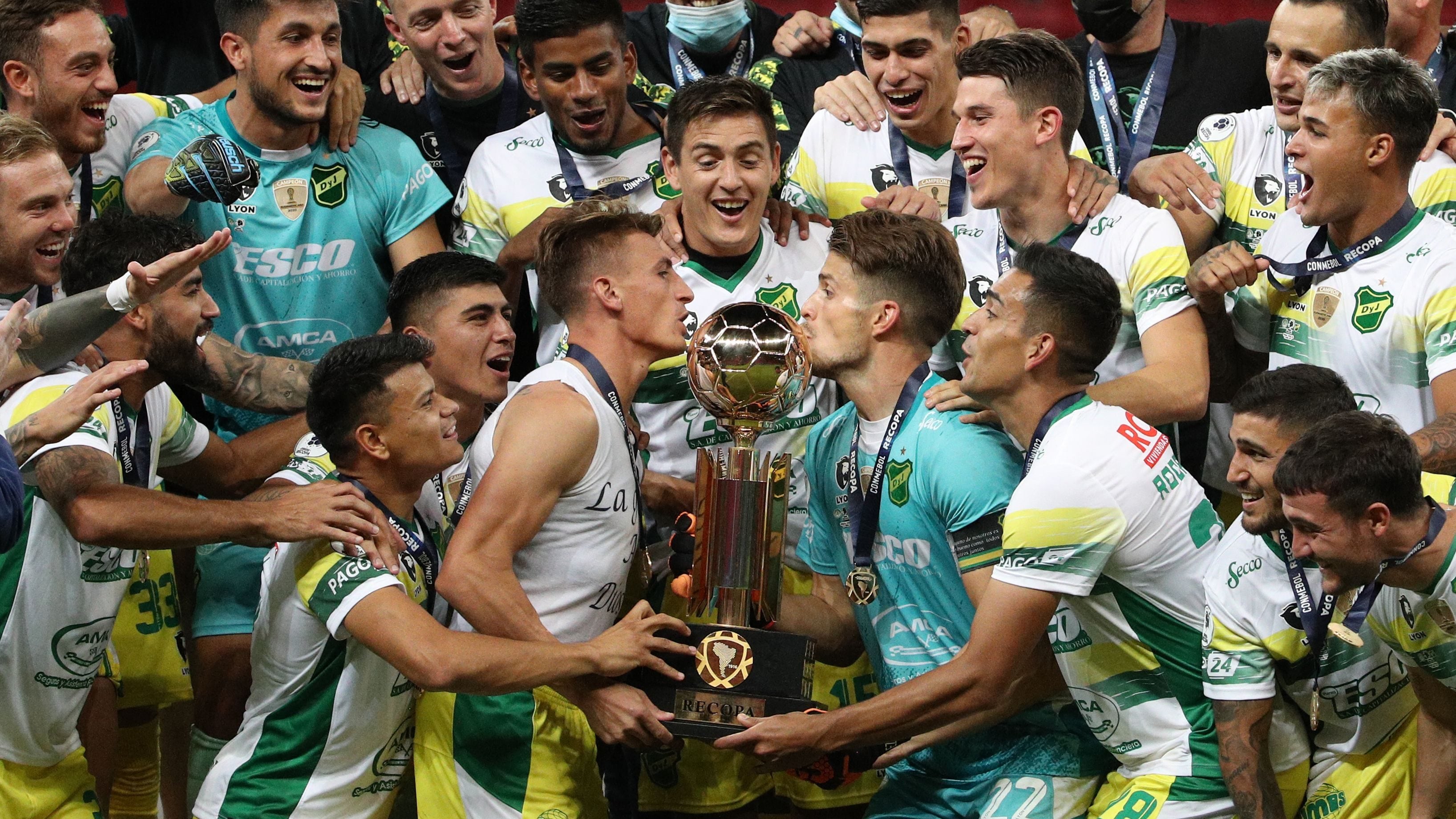 Argentina's Defensa y Justicia footballers raise the trophy of the Recopa Sudamericana after wining the final football match against Brazil's Palmeiras at the Mane Garrincha Stadium in Brasilia, on April 15, 2021. (Photo by Buda Mendes / POOL / AFP) (Photo by BUDA MENDES/POOL/AFP via Getty Images)