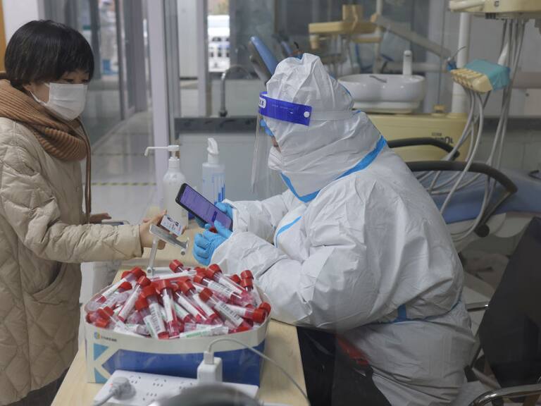 Una persona muestra su identidad al ingresar a un servicio en Pekín