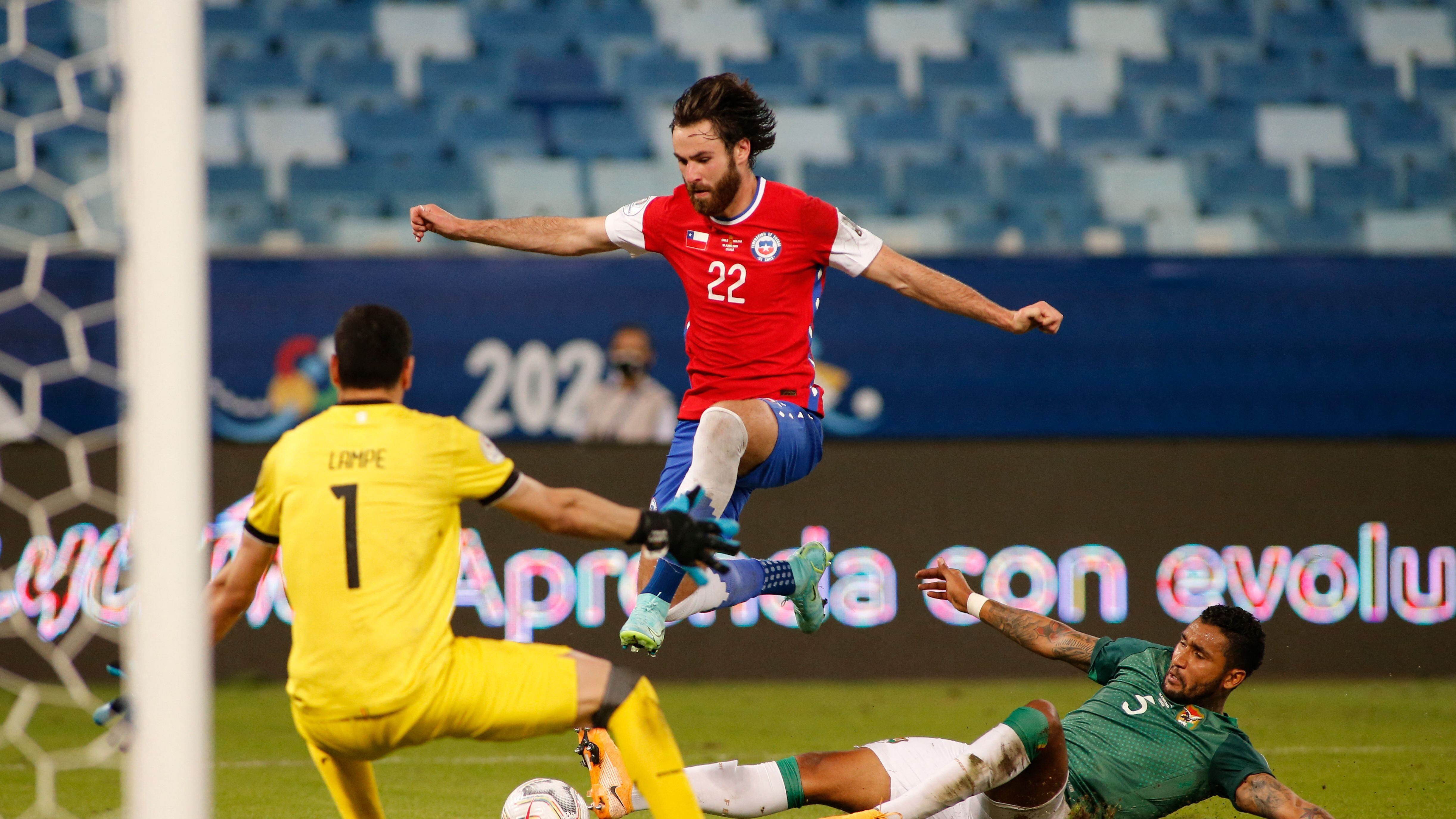 Bolivia's goalkeeper Carlos Lampe (L) blocks the goal as Bolivia's Adrian Jusino (R) marks Chile's Ben Brereton during their Conmebol Copa America 2021 football tournament group phase match at the Pantanal Arena in Cuiaba, Brazil, on June 18, 2021. (Photo by SILVIO AVILA / AFP) (Photo by SILVIO AVILA/AFP via Getty Images)