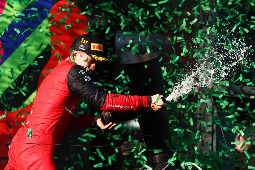 MELBOURNE, AUSTRALIA - APRIL 10: Race winner Charles Leclerc of Monaco and Ferrari celebrates on the podium during the F1 Grand Prix of Australia at Melbourne Grand Prix Circuit on April 10, 2022 in Melbourne, Australia. (Photo by Bryn Lennon - Formula 1/Formula 1 via Getty Images)