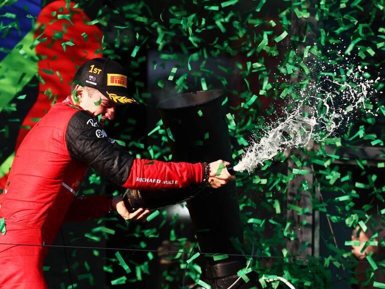 MELBOURNE, AUSTRALIA - APRIL 10: Race winner Charles Leclerc of Monaco and Ferrari celebrates on the podium during the F1 Grand Prix of Australia at Melbourne Grand Prix Circuit on April 10, 2022 in Melbourne, Australia. (Photo by Bryn Lennon - Formula 1/Formula 1 via Getty Images)