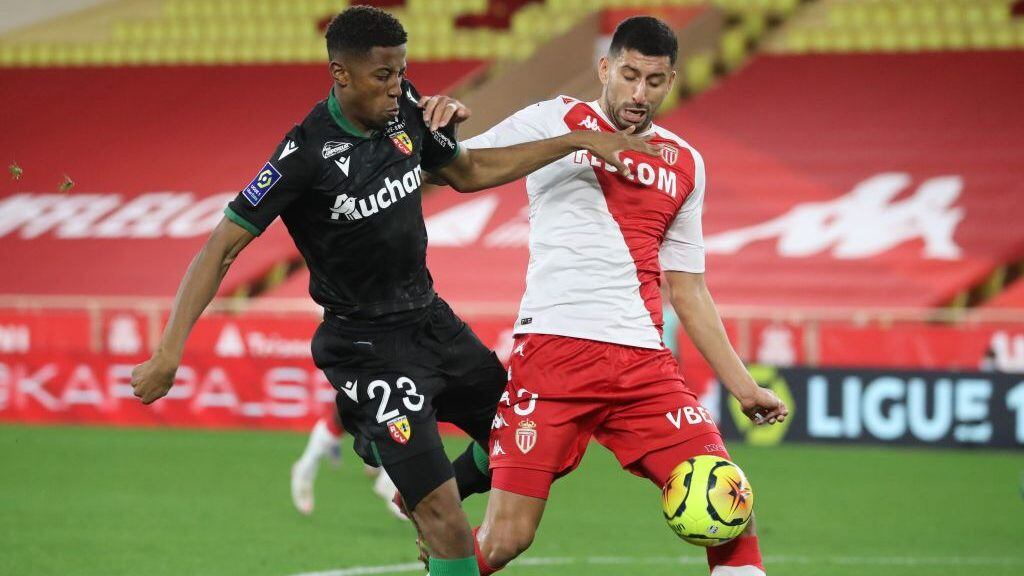 Lens' French forward Simon Banza (L) fights for the ball with Monaco's Chilean defender Guillermo Maripan during the French L1 football match between AS Monaco and RC Lens at the Louis II stadium in Monaco, on December 16, 2020. (Photo by Valery HACHE / AFP) (Photo by VALERY HACHE/AFP via Getty Images)