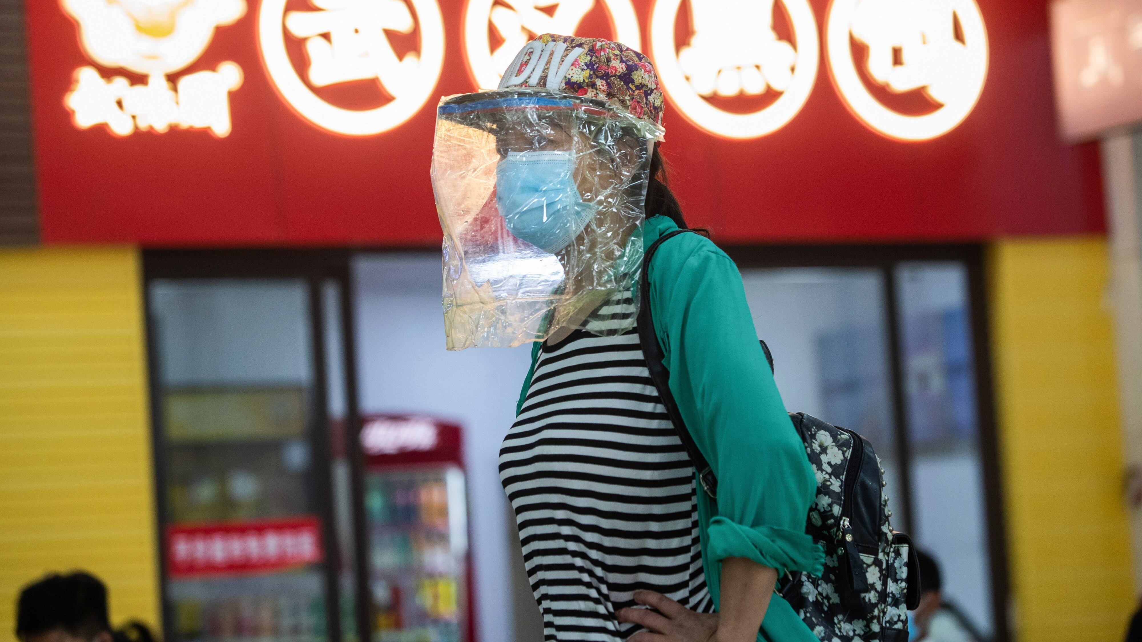 A passenger wearing a face shield is seen at a long-distance bus station in Wuhan in China's central Hubei province on April 30, 2020, ahead of the Labor Day holiday which starts on May 1. - China has largely brought the coronavirus under control within its borders since the outbreak first emerged in the city of Wuhan late last year. (Photo by STR / AFP) / China OUT (Photo by STR/AFP via Getty Images)