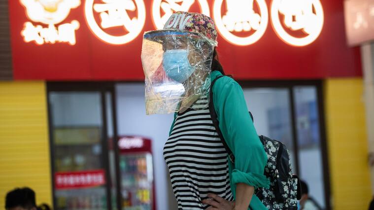 A passenger wearing a face shield is seen at a long-distance bus station in Wuhan in China's central Hubei province on April 30, 2020, ahead of the Labor Day holiday which starts on May 1. - China has largely brought the coronavirus under control within its borders since the outbreak first emerged in the city of Wuhan late last year. (Photo by STR / AFP) / China OUT (Photo by STR/AFP via Getty Images)