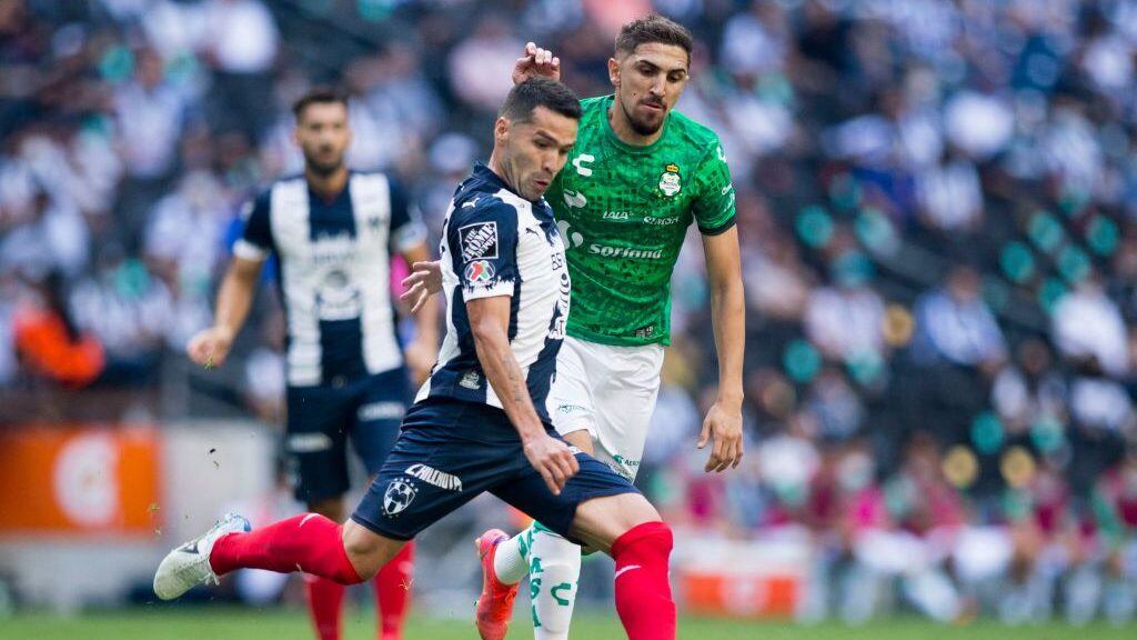 Celso Ortiz (L) of Monterrey is marked by Diego Valdes of Santos during their Mexican Clausura football tournament match at the BBVA Bancomer stadium in Monterrey, Mexico, on May 16, 2021. (Photo by Julio Cesar AGUILAR / AFP) (Photo by JULIO CESAR AGUILAR/AFP via Getty Images)