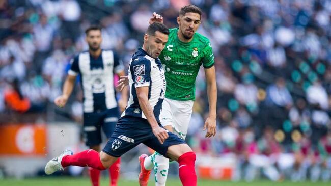 Celso Ortiz (L) of Monterrey is marked by Diego Valdes of Santos during their Mexican Clausura football tournament match at the BBVA Bancomer stadium in Monterrey, Mexico, on May 16, 2021. (Photo by Julio Cesar AGUILAR / AFP) (Photo by JULIO CESAR AGUILAR/AFP via Getty Images)