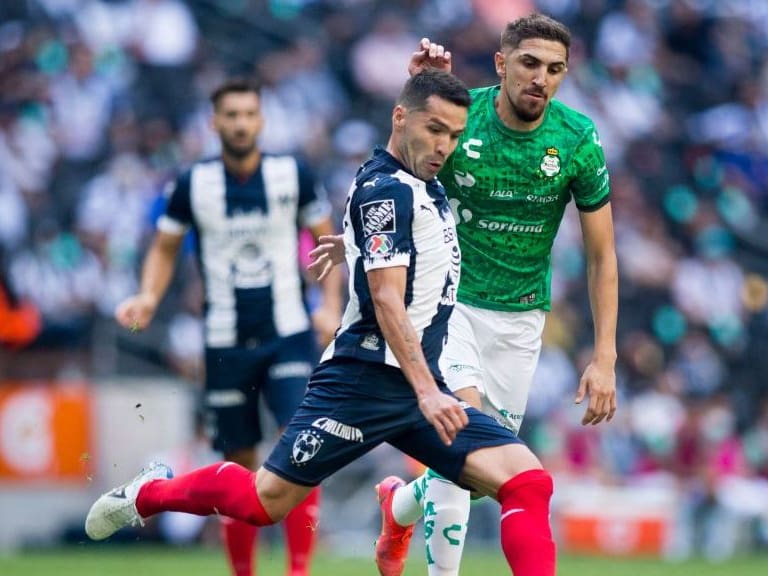 Celso Ortiz (L) of Monterrey is marked by Diego Valdes of Santos during their Mexican Clausura football tournament match at the BBVA Bancomer stadium in Monterrey, Mexico, on May 16, 2021. (Photo by Julio Cesar AGUILAR / AFP) (Photo by JULIO CESAR AGUILAR/AFP via Getty Images)