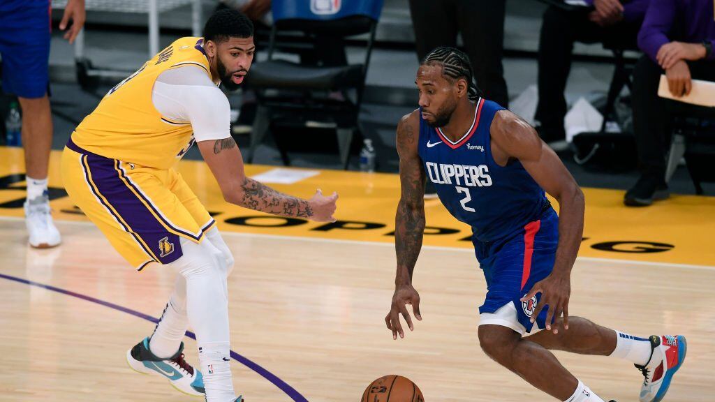 LOS ANGELES, CALIFORNIA - DECEMBER 22:  Kawhi Leonard #2 of the LA Clippers dribbles past Anthony Davis #3 of the Los Angeles Lakers during a 116-109 LA Clippers win in the season opening game at Staples Center on December 22, 2020 in Los Angeles, California. NOTE TO USER: User expressly acknowledges and agrees that, by downloading and or using this photograph, User is consenting to the terms and conditions of the Getty Images License Agreement. (Photo by Harry How/Getty Images)