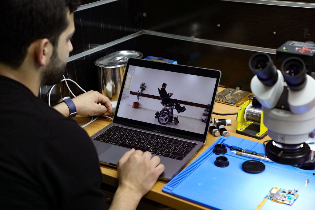 Jamal Shakhtor, a 26-year-old Palestinian student in industrial automation, shows on his computer screen a transformable disability chair of his making, that he presented last year at the Qatari Stars of Science reality-TV program dedicated to innovation, at his workshop in the West Bank town of Bethlehem, on February 5,2021. (Photo by HAZEM BADER / AFP) (Photo by HAZEM BADER/AFP via Getty Images)