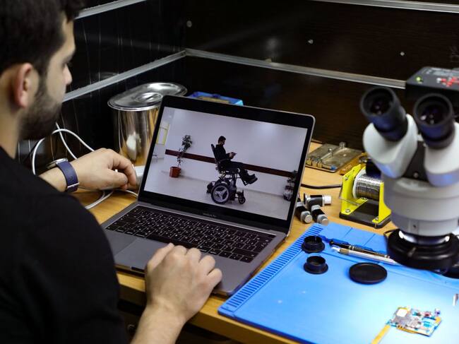 Jamal Shakhtor, a 26-year-old Palestinian student in industrial automation, shows on his computer screen a transformable disability chair of his making, that he presented last year at the Qatari Stars of Science reality-TV program dedicated to innovation, at his workshop in the West Bank town of Bethlehem, on February 5,2021. (Photo by HAZEM BADER / AFP) (Photo by HAZEM BADER/AFP via Getty Images)
