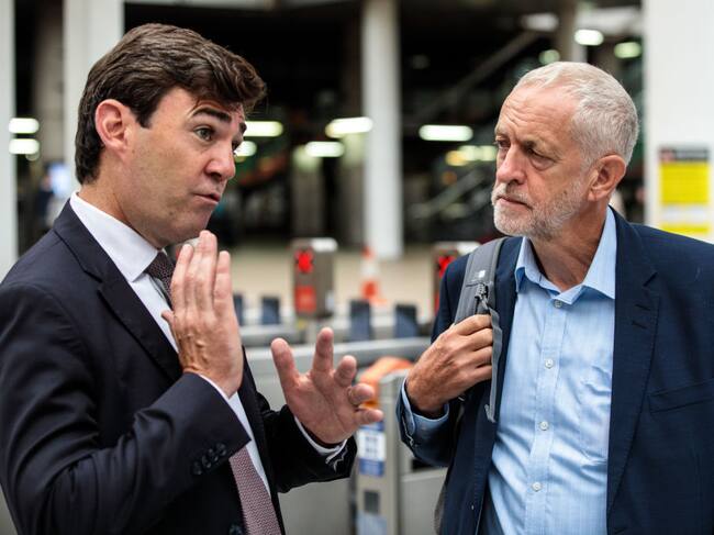 MANCHESTER, ENGLAND - SEPTEMBER 03: Labour Leader Jeremy Corbyn (R) is greeted by Mayor of Greater Manchester Andy Burnham (L) as he arrives at Manchester Victoria Station from Liverpool during a tour the North of England by rail today on September 3, 2018 in Manchester, England. Labour under Mr Corbyn are proposing a 'Crossrail for the North' linking the North East and North West of England with a new rail line. (Photo by Jack Taylor/Getty Images)