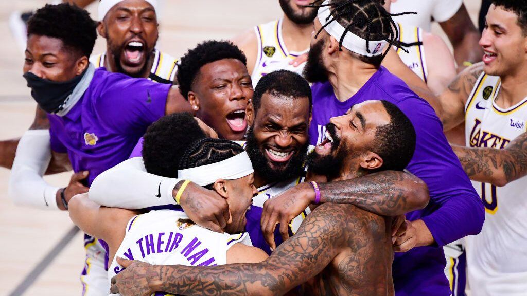 LAKE BUENA VISTA, FLORIDA - OCTOBER 11: LeBron James #23 of the Los Angeles Lakers celebrates with Quinn Cook #28 of the Los Angeles Lakers and teammates after winning the 2020 NBA Championship in Game Six of the 2020 NBA Finals at AdventHealth Arena at the ESPN Wide World Of Sports Complex on October 11, 2020 in Lake Buena Vista, Florida. NOTE TO USER: User expressly acknowledges and agrees that, by downloading and or using this photograph, User is consenting to the terms and conditions of the Getty Images License Agreement.  (Photo by Douglas P. DeFelice/Getty Images)