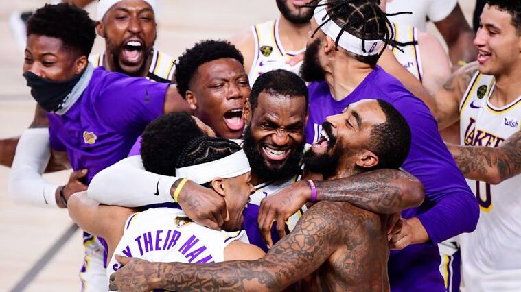 LAKE BUENA VISTA, FLORIDA - OCTOBER 11: LeBron James #23 of the Los Angeles Lakers celebrates with Quinn Cook #28 of the Los Angeles Lakers and teammates after winning the 2020 NBA Championship in Game Six of the 2020 NBA Finals at AdventHealth Arena at the ESPN Wide World Of Sports Complex on October 11, 2020 in Lake Buena Vista, Florida. NOTE TO USER: User expressly acknowledges and agrees that, by downloading and or using this photograph, User is consenting to the terms and conditions of the Getty Images License Agreement. (Photo by Douglas P. DeFelice/Getty Images)
