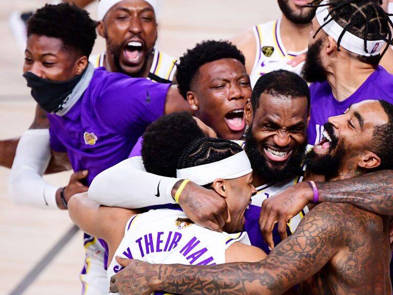 LAKE BUENA VISTA, FLORIDA - OCTOBER 11: LeBron James #23 of the Los Angeles Lakers celebrates with Quinn Cook #28 of the Los Angeles Lakers and teammates after winning the 2020 NBA Championship in Game Six of the 2020 NBA Finals at AdventHealth Arena at the ESPN Wide World Of Sports Complex on October 11, 2020 in Lake Buena Vista, Florida. NOTE TO USER: User expressly acknowledges and agrees that, by downloading and or using this photograph, User is consenting to the terms and conditions of the Getty Images License Agreement. (Photo by Douglas P. DeFelice/Getty Images)