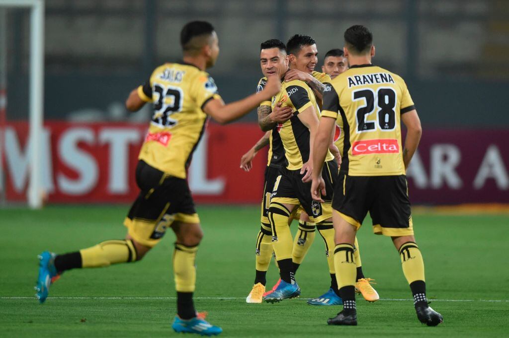 Chile's Coquimbo players celebrate after scoring against Peru's Sport Huancayo during their closed-door Copa Sudamericana round before the quarterfinals football match at the National Stadium in Lima, on December 2, 2020. (Photo by ERNESTO BENAVIDES / AFP) (Photo by ERNESTO BENAVIDES/AFP via Getty Images)