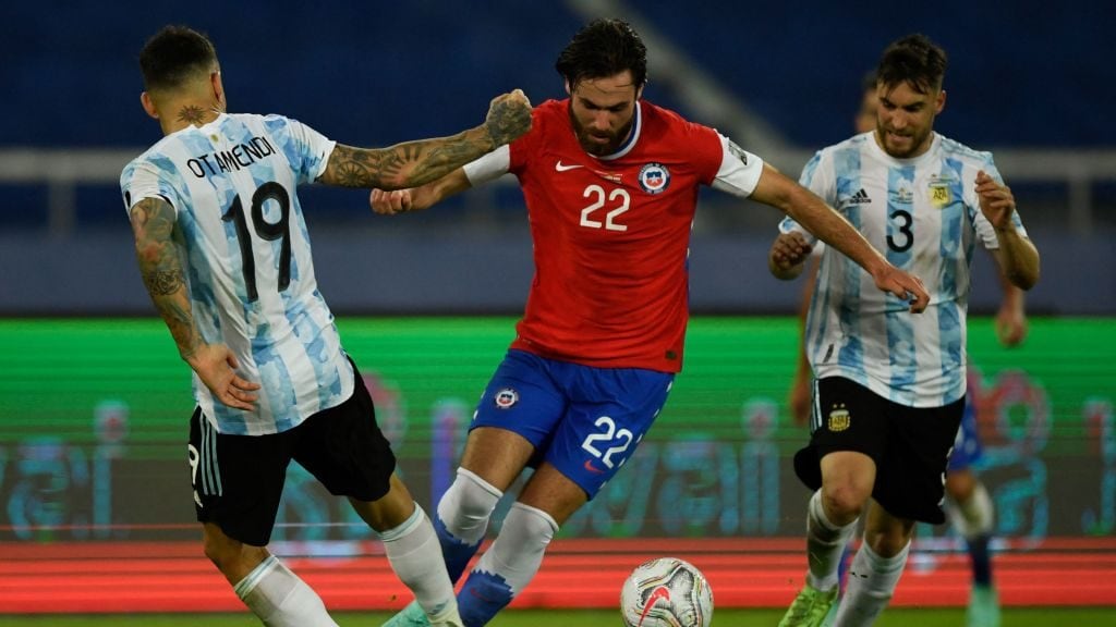 Chile's Ben Brereton (C) vies for the ball with Argentina's Nicolas Otamendi (L) and Nicolas Tagliafico during their Conmebol Copa America 2021 football tournament group phase match at the Nilton Santos Stadium in Rio de Janeiro, Brazil, on June 14, 2021. (Photo by MAURO PIMENTEL / AFP) (Photo by MAURO PIMENTEL/AFP via Getty Images)