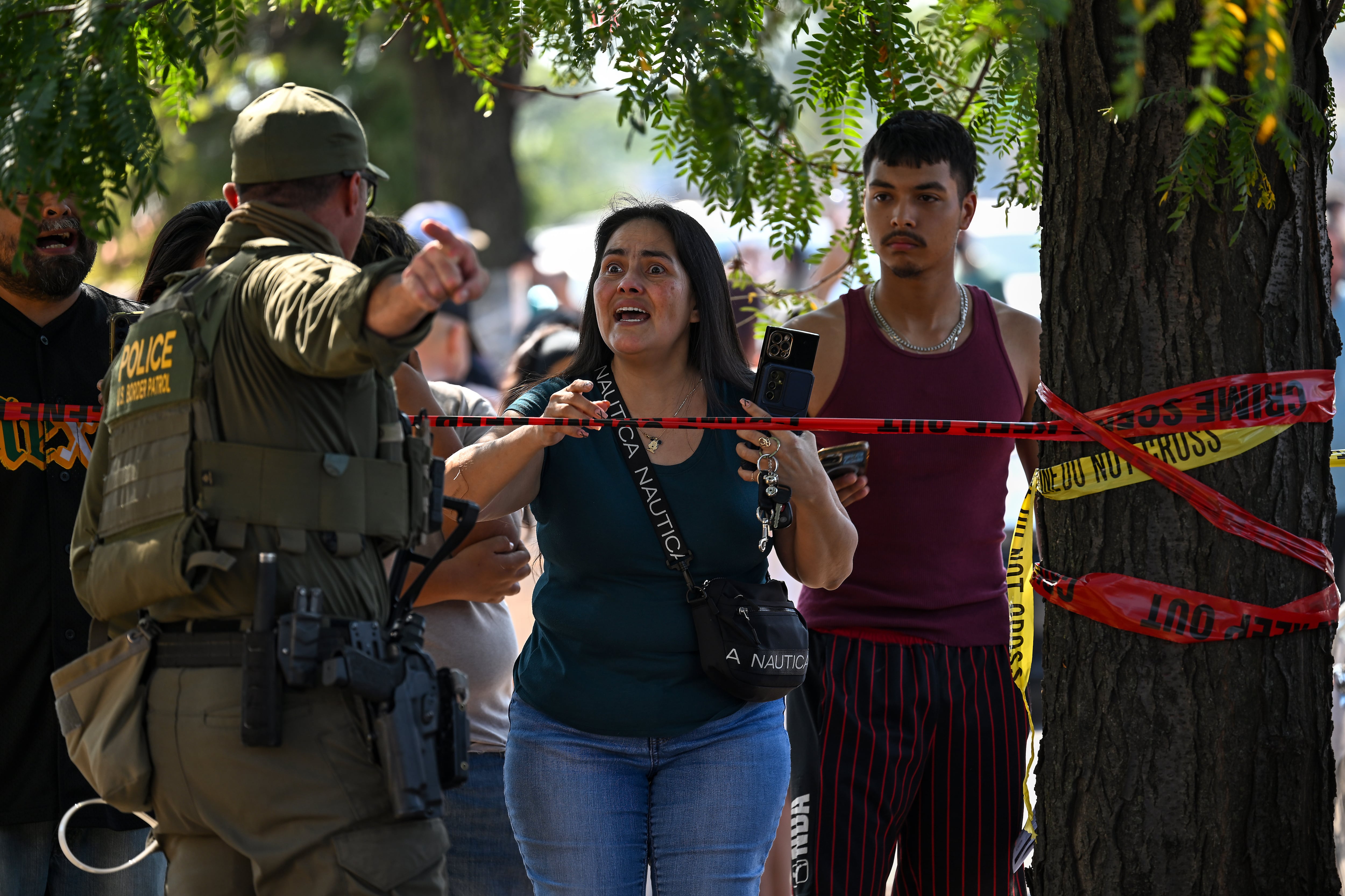 CHICAGO, ILLINOIS - OCTOBER 4: Elizebeth Ruiz argues with a Federal Agent after her son was arrested by agents along Kedzie Avenue in the Brighton Park Neighborhood as Federal Agents were investigating a shooting on October 4, 2025 in Chicago, Illinois. Federal Agents shot an individual in the area after a confrontation. President Donald Trumps's administration continues to enforce immigration laws in Chicago and the surrounding suburbs during Operation Midway Blitz. (Photo by Joshua Lott/The Washington Post via Getty Images)