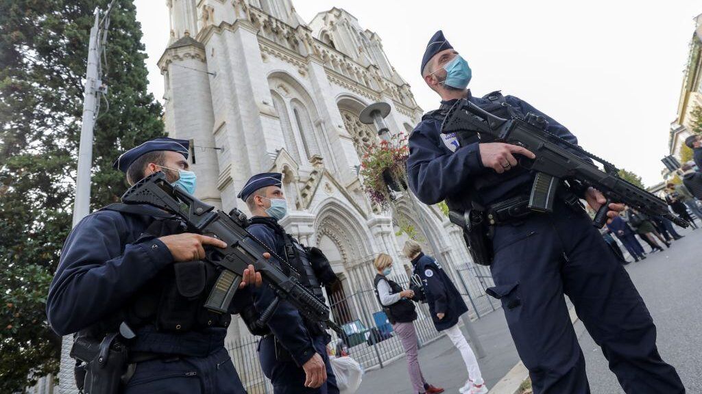 Police officers stand guard by the Notre-Dame de l'Assomption Basilica in Nice on October 29, 2020 after a knife-wielding man kills three people at the church, slitting the throat of at least one of them, in what officials are treating as the latest jihadist attack to rock the country. (Photo by ERIC GAILLARD / POOL / AFP) (Photo by ERIC GAILLARD/POOL/AFP via Getty Images)