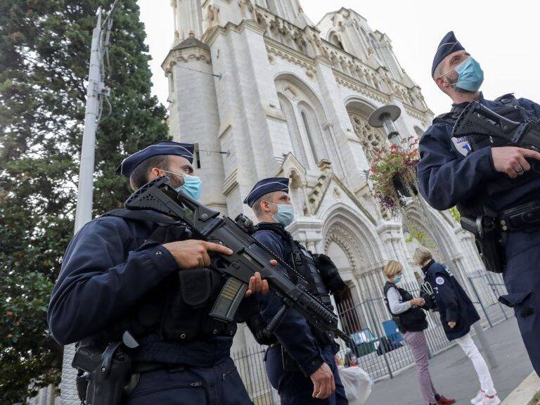 Police officers stand guard by the Notre-Dame de l&#039;Assomption Basilica in Nice on October 29, 2020 after a knife-wielding man kills three people at the church, slitting the throat of at least one of them, in what officials are treating as the latest jihadist attack to rock the country. (Photo by ERIC GAILLARD / POOL / AFP) (Photo by ERIC GAILLARD/POOL/AFP via Getty Images)