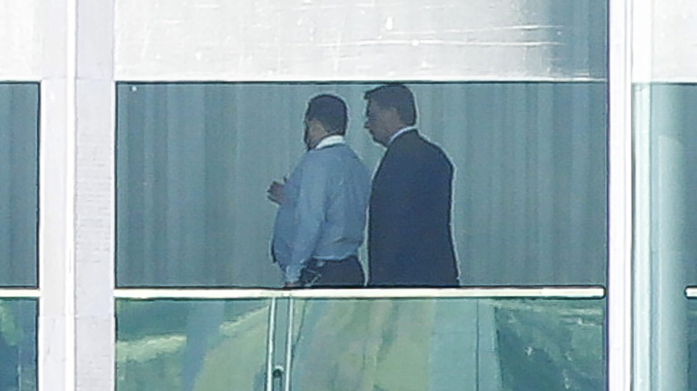 Brazilian President Jair Bolsonaro (R) is pictured with an adviser, inside Alvorada Palace in Brasilia, on March 12, 2020 after being tested for the new coronavirus COVID-19 after a top aide contracted the disease following a trip on which both met with US President Donald Trump. (Photo by Sergio LIMA / AFP) (Photo by SERGIO LIMA/AFP via Getty Images)