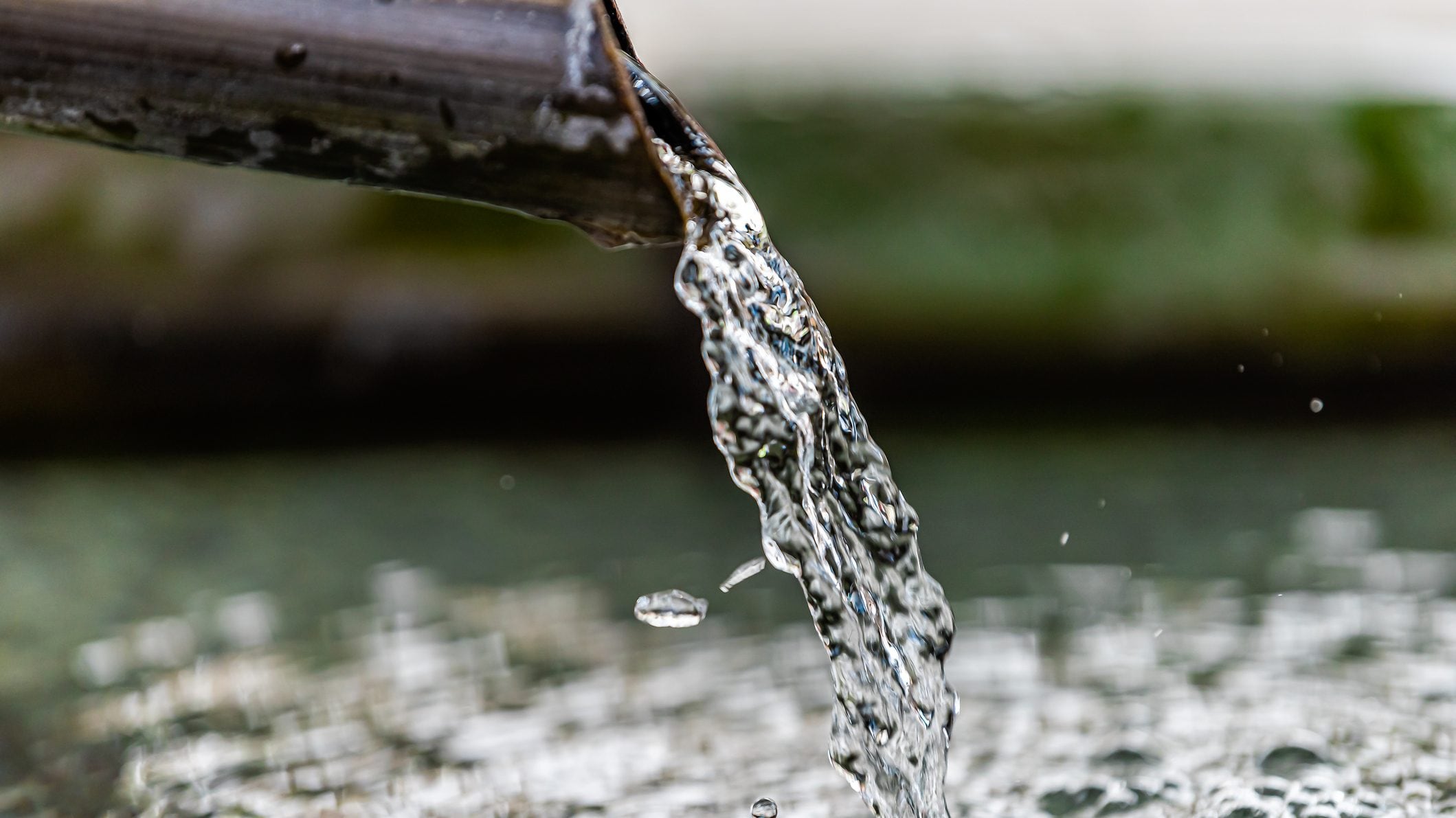 Purification water fountain in Kyoto, Japan with liquid running from spout faucet