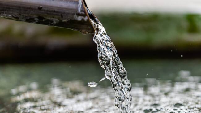 Purification water fountain in Kyoto, Japan with liquid running from spout faucet