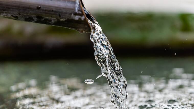 Purification water fountain in Kyoto, Japan with liquid running from spout faucet