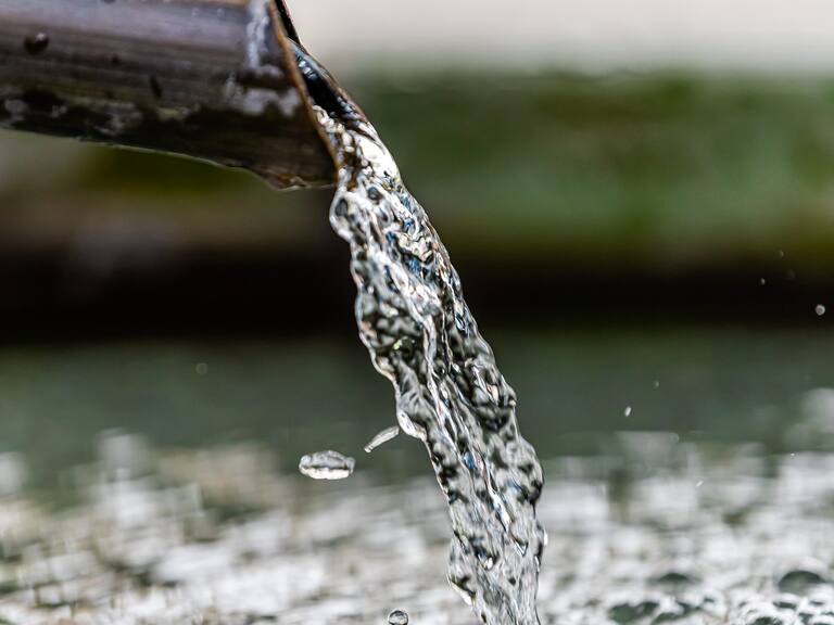 Purification water fountain in Kyoto, Japan with liquid running from spout faucet