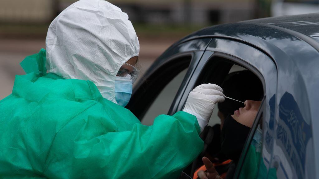 A person undergoes a PCR test for COVID-19 at a testing facility set up in front of the Uruguayan Congress in Montevideo on December 18, 2020, amid the novel coronavirus pandemic. - The Uruguayan Senate on Friday approved a bill to limit the right to assembly, following a spike in the number of COVID-19 cases in the South American country. (Photo by Pablo PORCIUNCULA / AFP) (Photo by PABLO PORCIUNCULA/AFP via Getty Images)